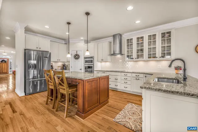 a kitchen with granite countertop cabinets stainless steel appliances and a counter space