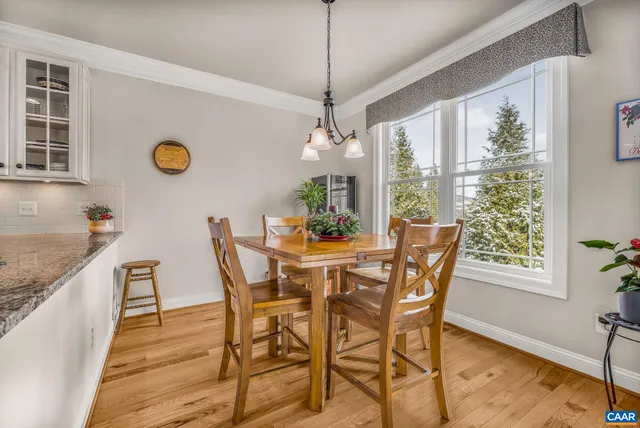 a view of a patio with table and chairs with wooden floor and fence
