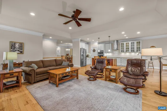 a spacious bedroom with a bed and a chandelier