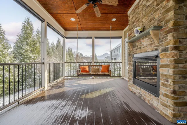 a view of a patio with table and chairs and couches with wooden fence