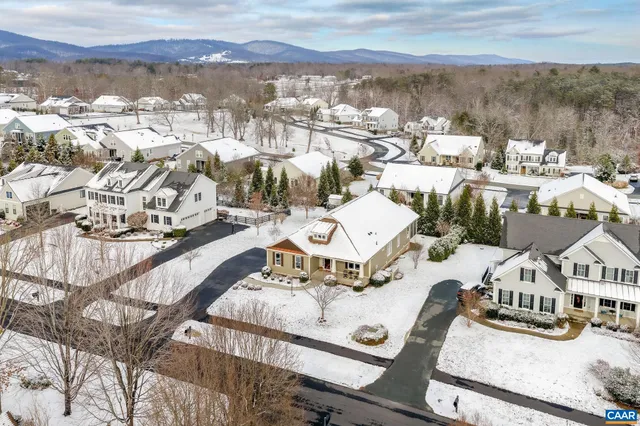 a dining room with furniture a chandelier and wooden floor