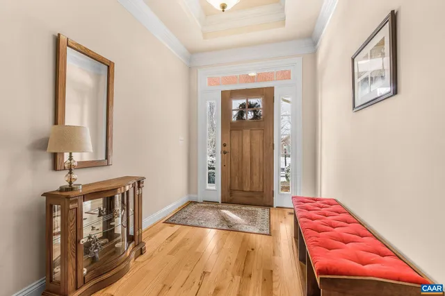 a kitchen with stainless steel appliances granite countertop a stove a refrigerator a sink a dining table and chairs with wooden floor