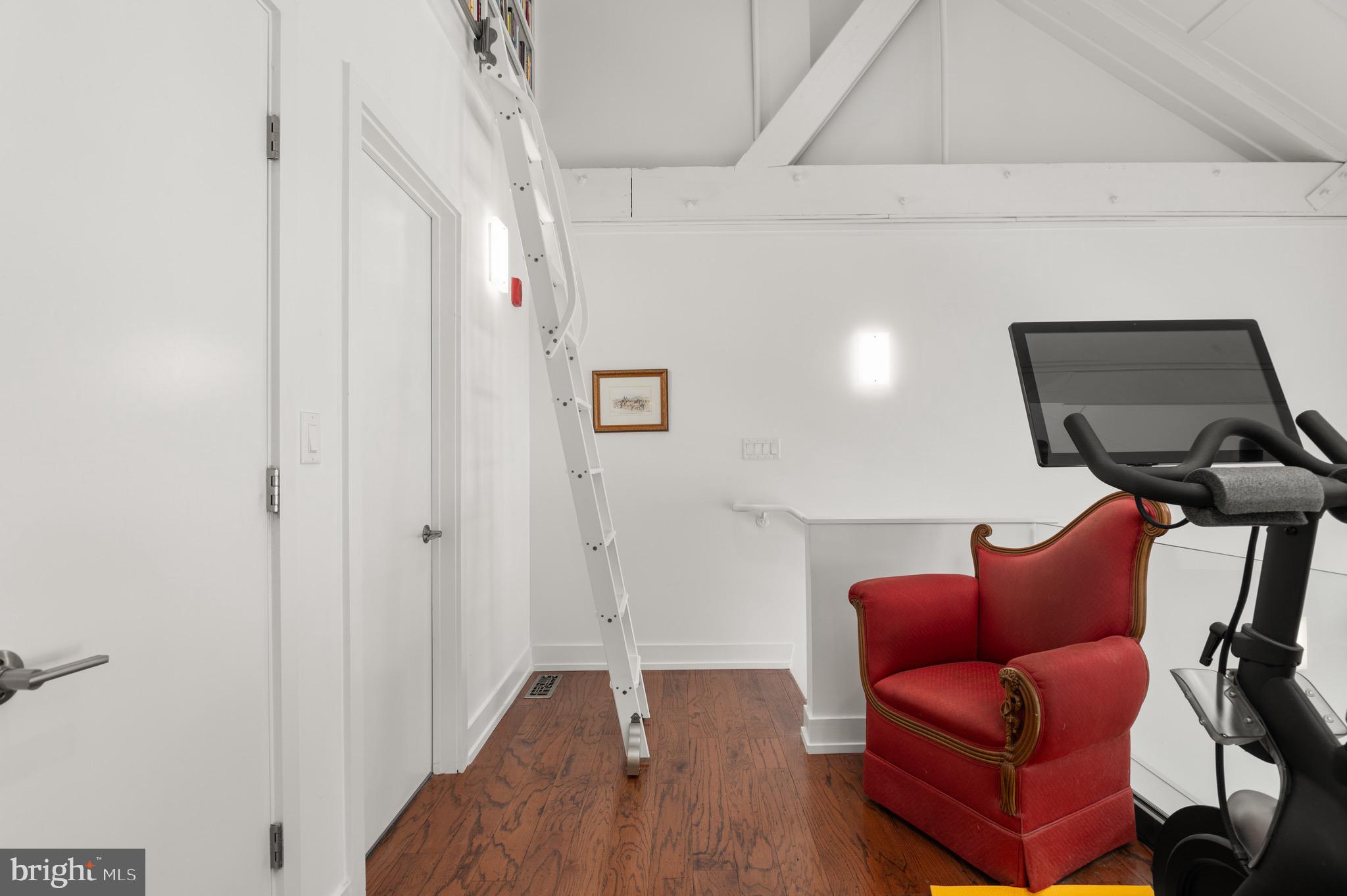 2747 Linden Lane, Unit 203 Silver Spring, MD 20910 - Photo 12 of 34 a hallway with a couch and dresser with wooden floor