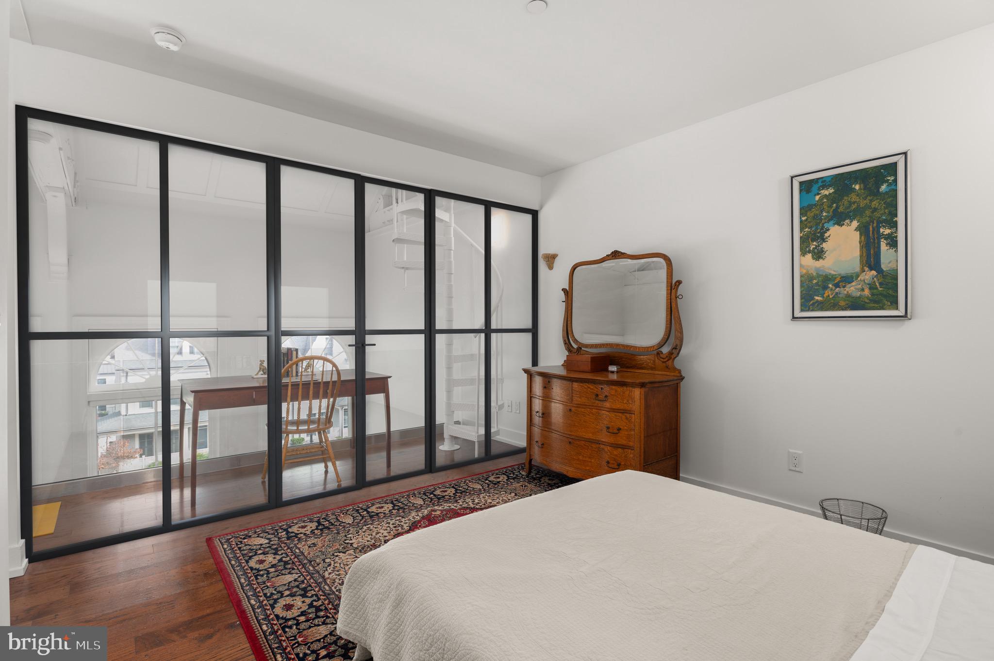 2747 Linden Lane, Unit 203 Silver Spring, MD 20910 - Photo 14 of 34 a bedroom with a bed and wooden floor
