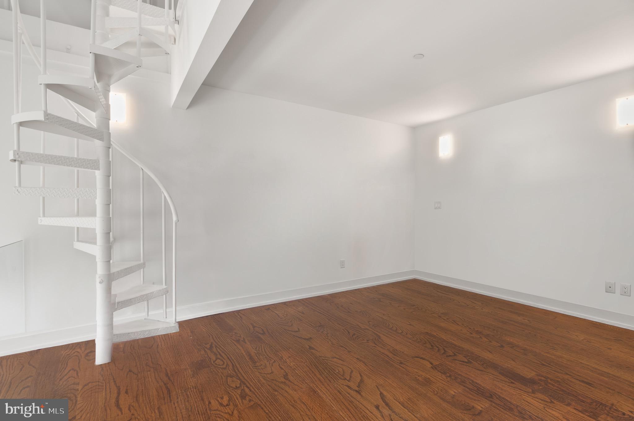 2747 Linden Lane, Unit 203 Silver Spring, MD 20910 - Photo 17 of 34 an empty room with wooden floor and windows