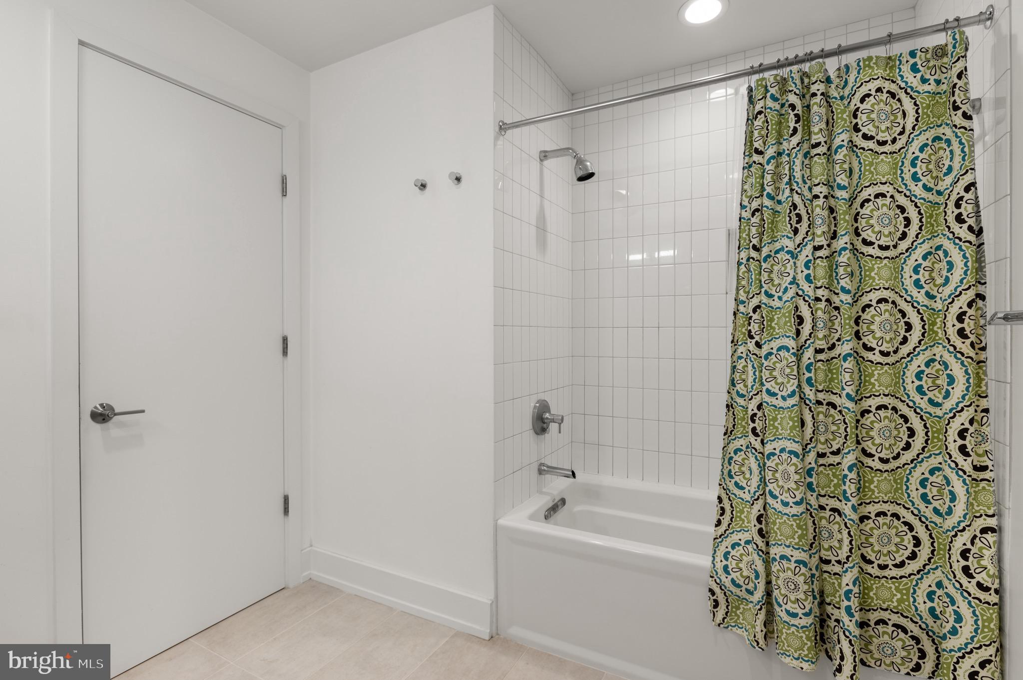 2747 Linden Lane, Unit 203 Silver Spring, MD 20910 - Photo 20 of 34 a bathroom with a bathtub and shower