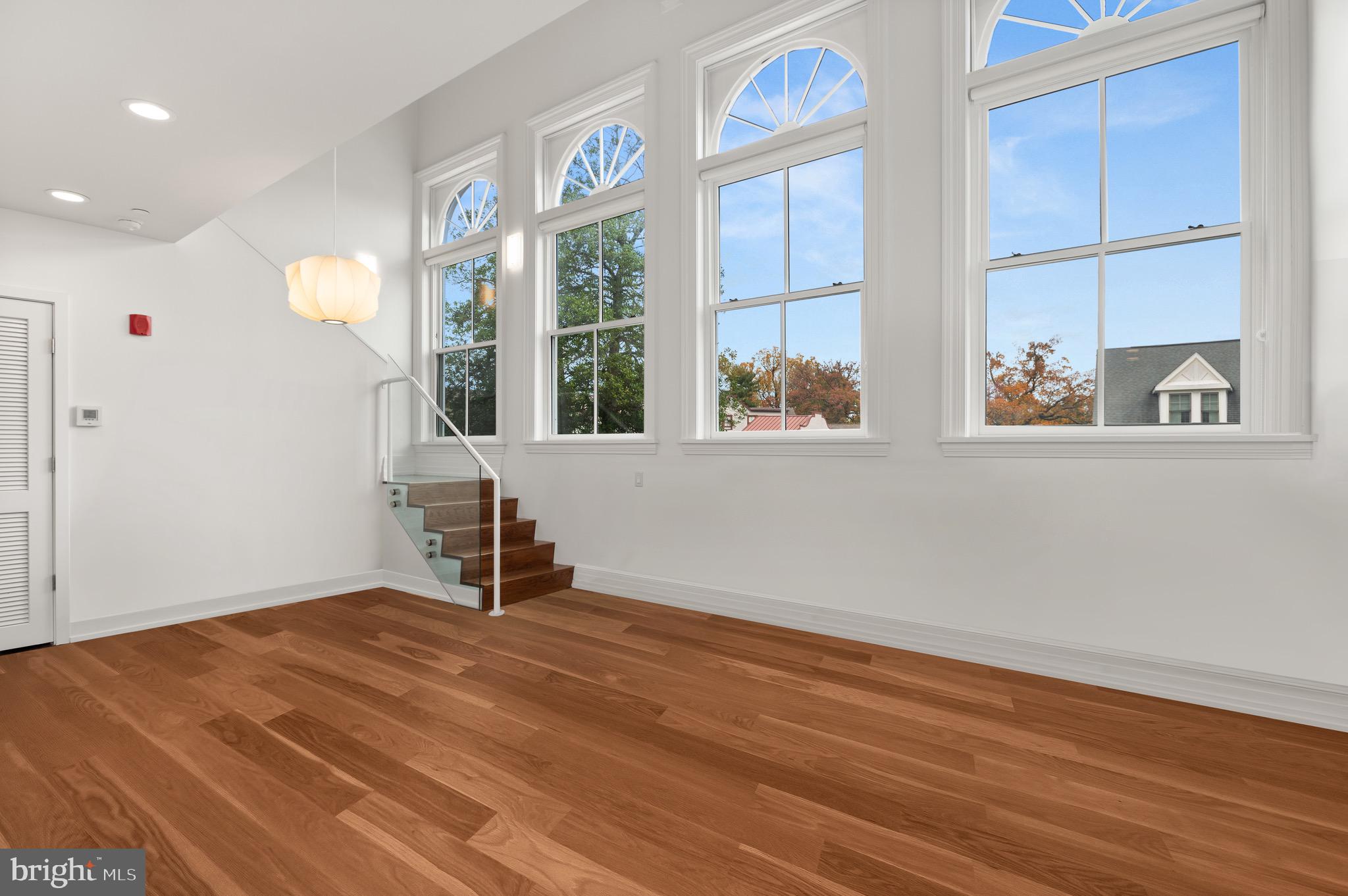 2747 Linden Lane, Unit 203 Silver Spring, MD 20910 - Photo 10 of 34 an empty room with wooden floor and windows
