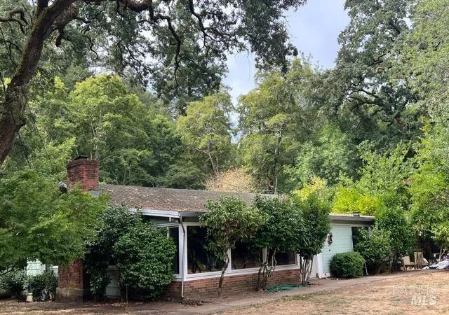 a view of a house with a tree in front