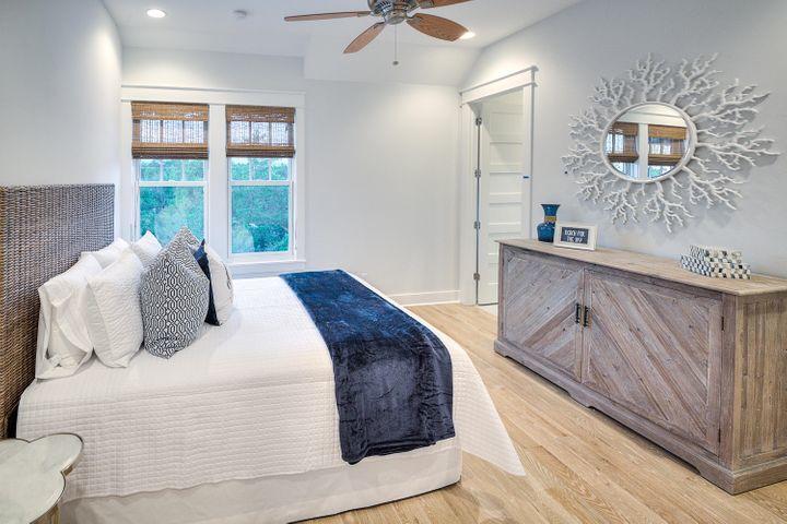 77 Shore Bridge Cir Inlet Beach Inlet Beach, FL 32461 - Photo 13 of 20 a bedroom with a large bed and a wooden floor