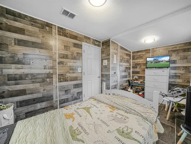 a bedroom with a bed and a view of walk in closet