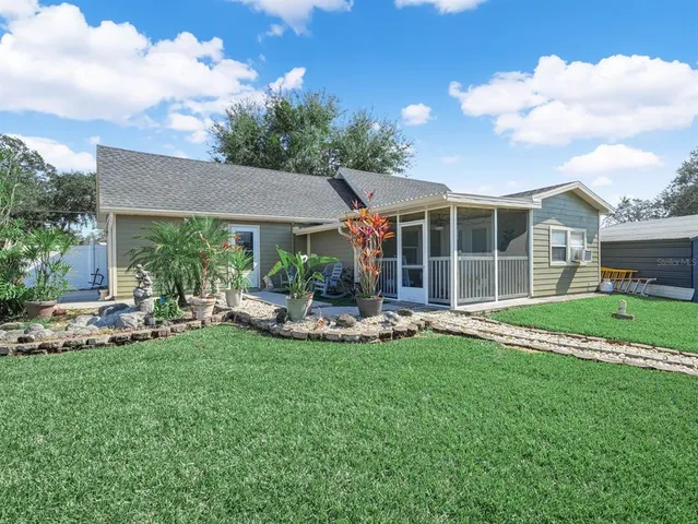 a view of a house with backyard porch and sitting area