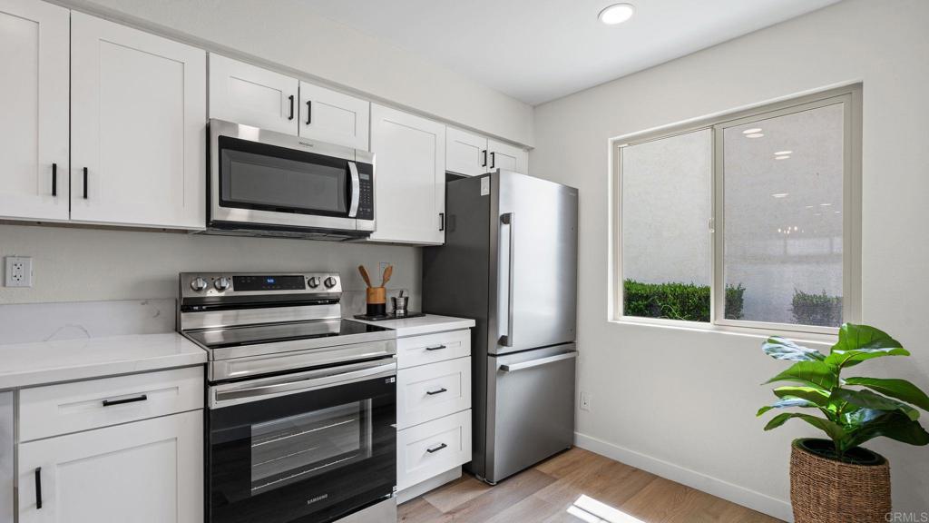 134 Espanas Escondido, CA 92026 - Photo 2 of 33 a kitchen with stainless steel appliances white cabinets and a stove