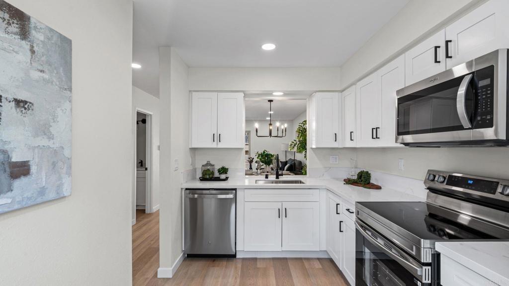 134 Espanas Escondido, CA 92026 - Photo 5 of 33 a kitchen with white cabinets stainless steel appliances and sink