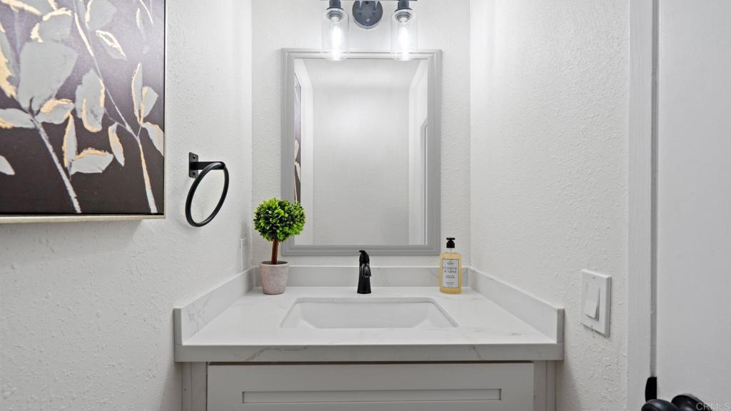 134 Espanas Escondido, CA 92026 - Photo 8 of 33 a bathroom with a sink and a mirror