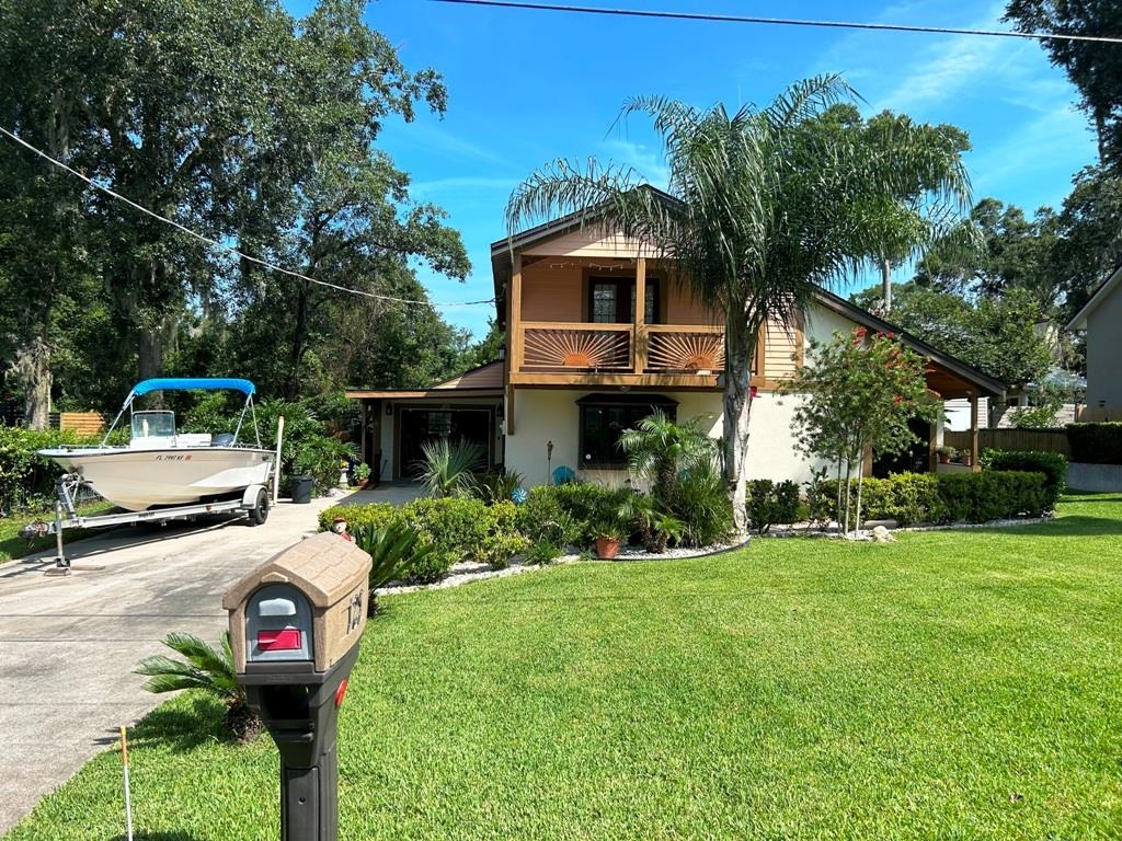 125 Saturn Road St. Augustine, FL 32086 - Photo 1 of 44 a front view of a house with a yard and trees