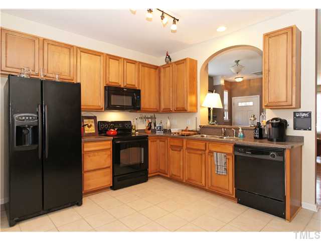 7721 Winners Edge Street Raleigh, NC 27617 - Photo 6 of 20 a kitchen with stainless steel appliances granite countertop a refrigerator stove and sink