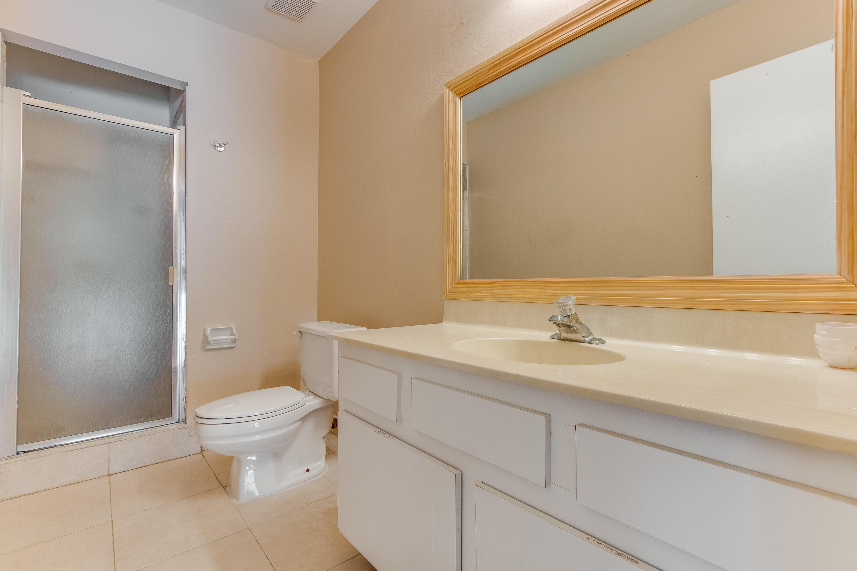 9273 Ketay Circle Boca Raton, FL 33428 - Photo 18 of 27 a bathroom with a granite countertop sink toilet and a mirror