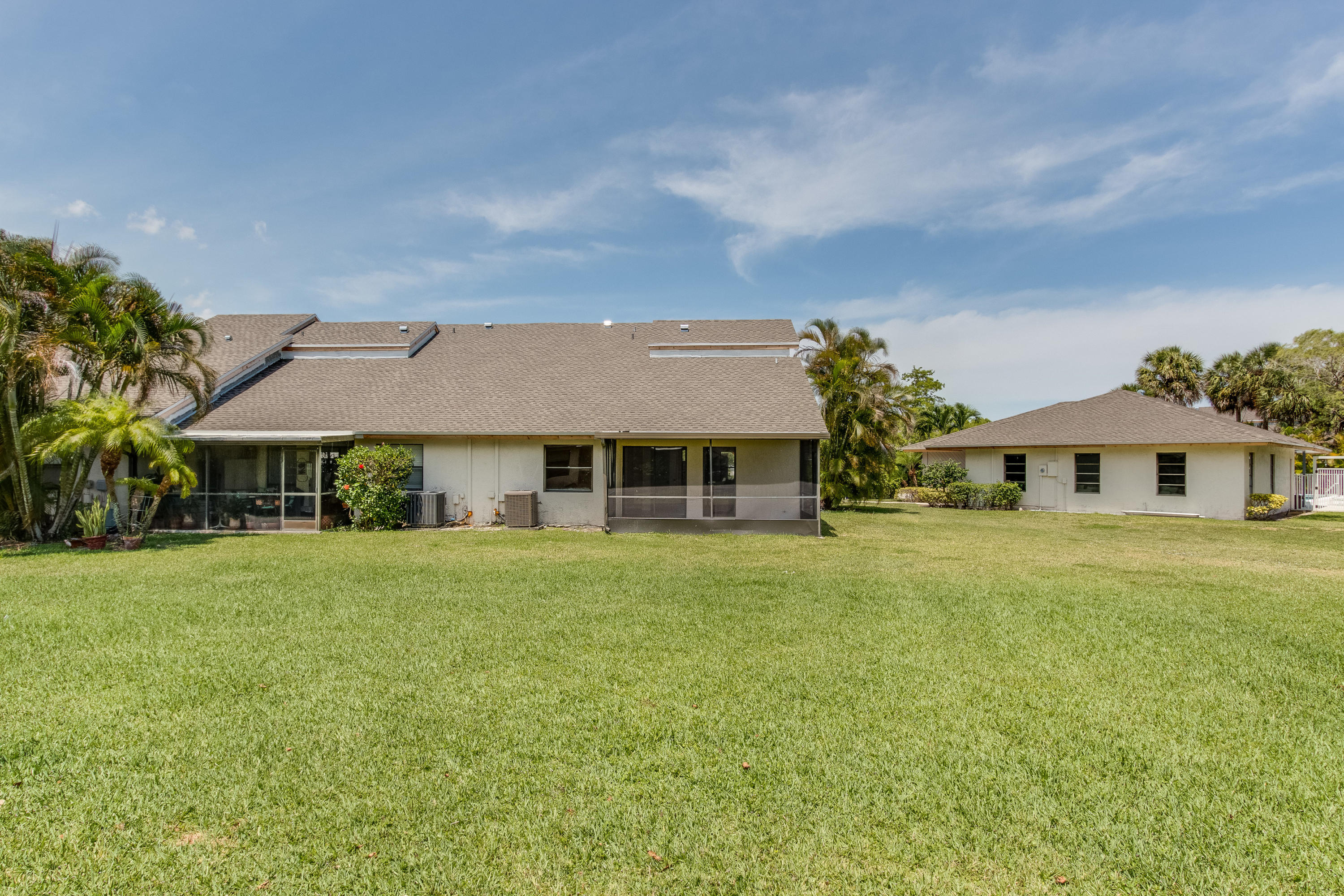 9273 Ketay Circle Boca Raton, FL 33428 - Photo 24 of 27 a front view of a house with a garden