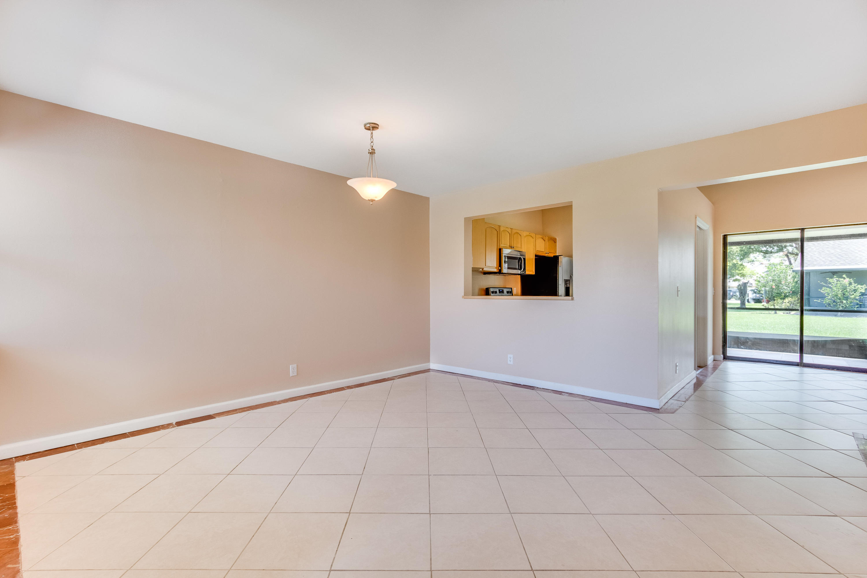 9273 Ketay Circle Boca Raton, FL 33428 - Photo 4 of 27 an empty room with wooden floor and windows