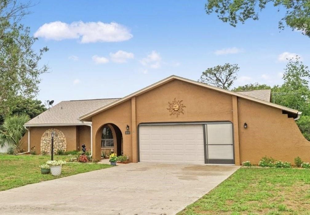 a front view of a house with a garden and yard