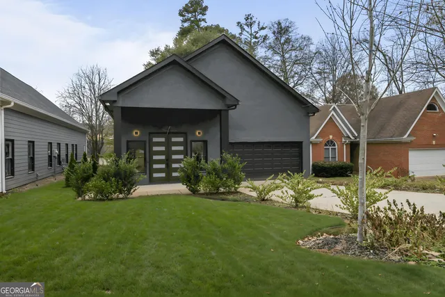 a kitchen with stainless steel appliances granite countertop a refrigerator a sink dishwasher a stove and a dining table with wooden floor