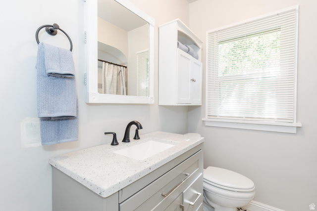 227 West 200 North Logan, UT 84321 - Photo 22 of 44 Bathroom featuring a vanity with a white composite countertop, undermount sink, and matte black faucet