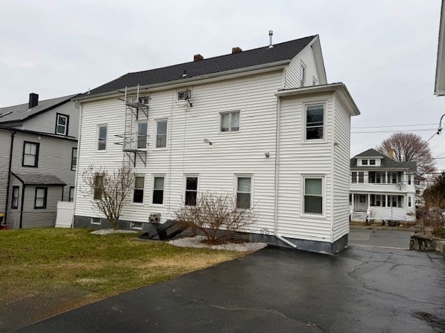 609 King Philip Street Fall River, MA 02724 - Photo 4 of 14 a view of a white house with large windows next to a road