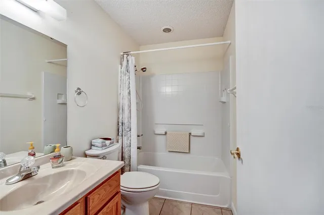 a bathroom with a sink toilet vanity and shower