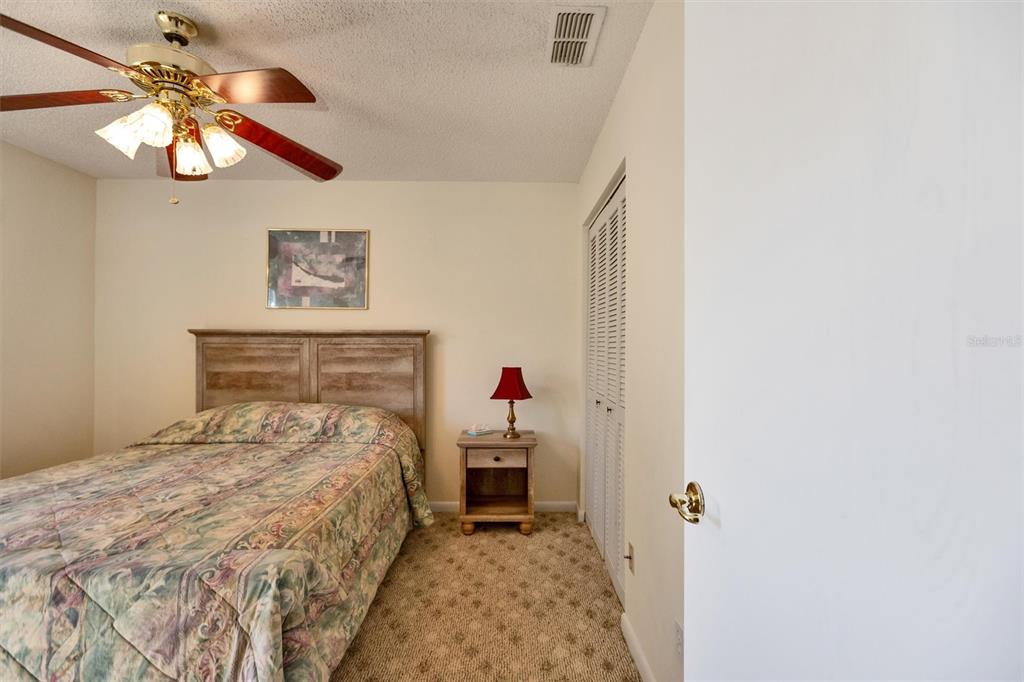 9485 Southwest 92nd Street Road Ocala, FL 34481 - Photo 17 of 38 a bedroom with a bed and a chandelier