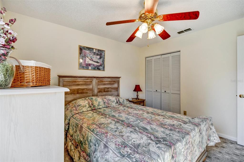 9485 Southwest 92nd Street Road Ocala, FL 34481 - Photo 19 of 38 a bedroom with a bed and a chandelier
