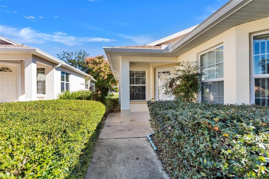 9485 Southwest 92nd Street Road Ocala, FL 34481 - Photo 2 of 38 a view of a house with a garden