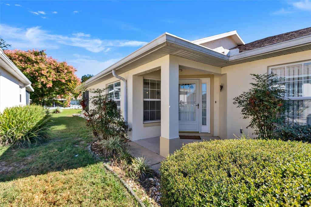 9485 Southwest 92nd Street Road Ocala, FL 34481 - Photo 3 of 38 a front view of house with a garden