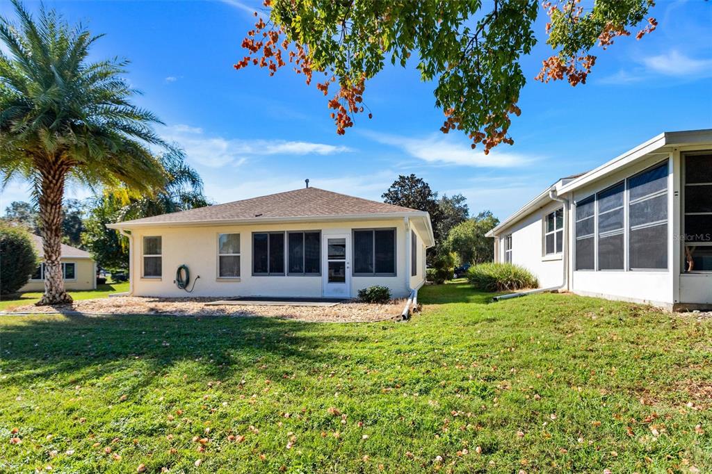 9485 Southwest 92nd Street Road Ocala, FL 34481 - Photo 5 of 38 a front view of a house with garden