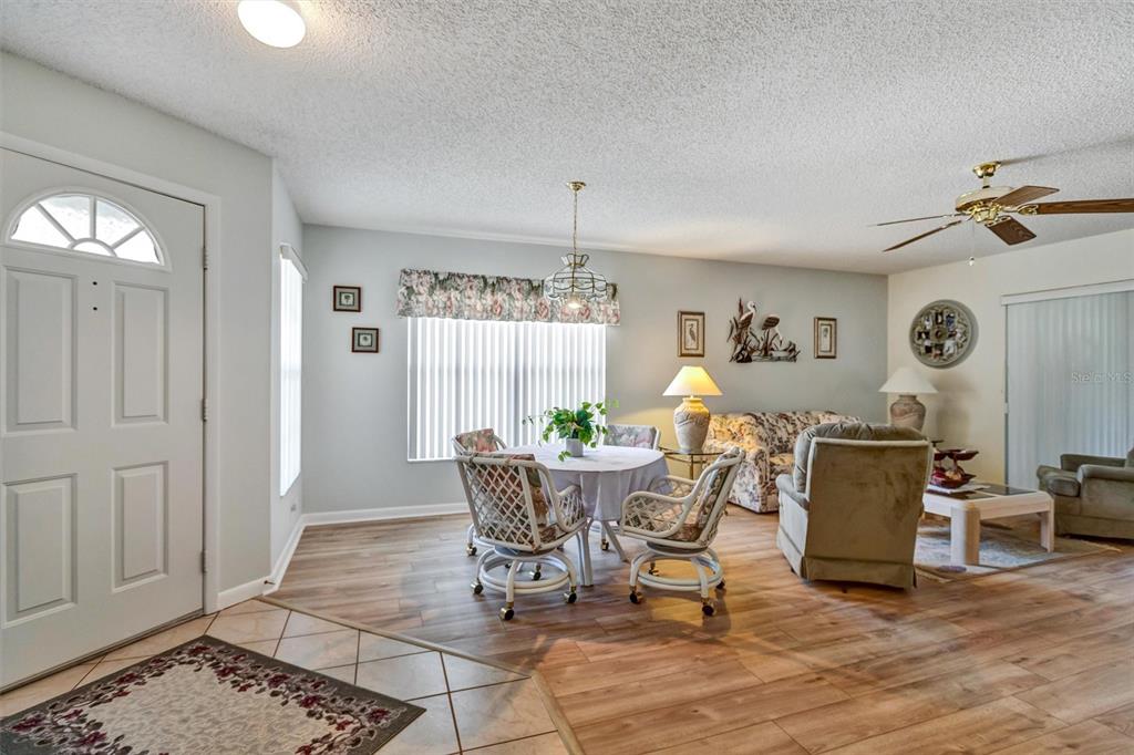 9485 Southwest 92nd Street Road Ocala, FL 34481 - Photo 8 of 38 a view of a dining room with furniture and wooden floor
