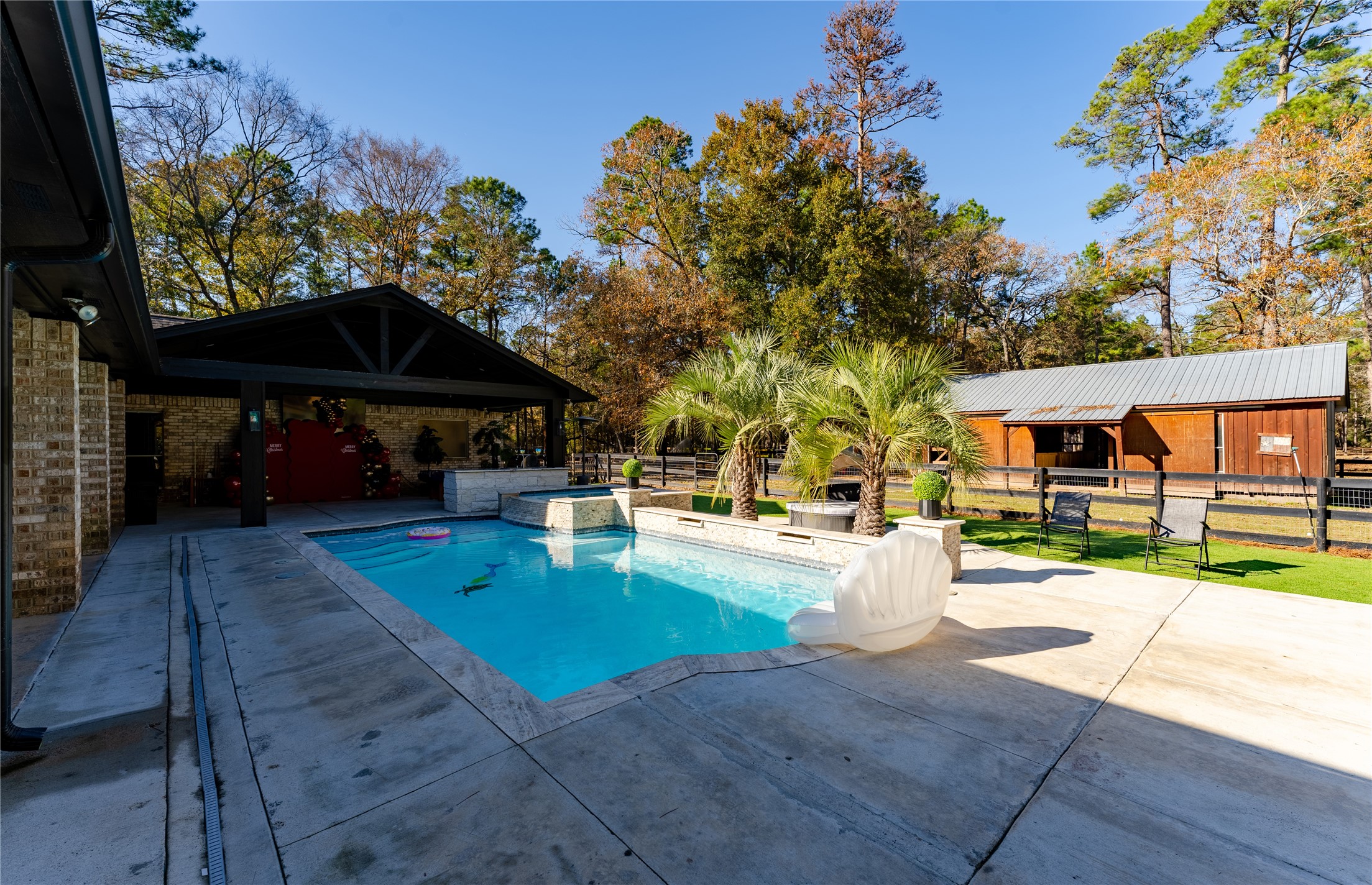 24102 Baneberry Road Magnolia, TX 77355 - Photo 17 of 39 a view of a swimming pool with a patio