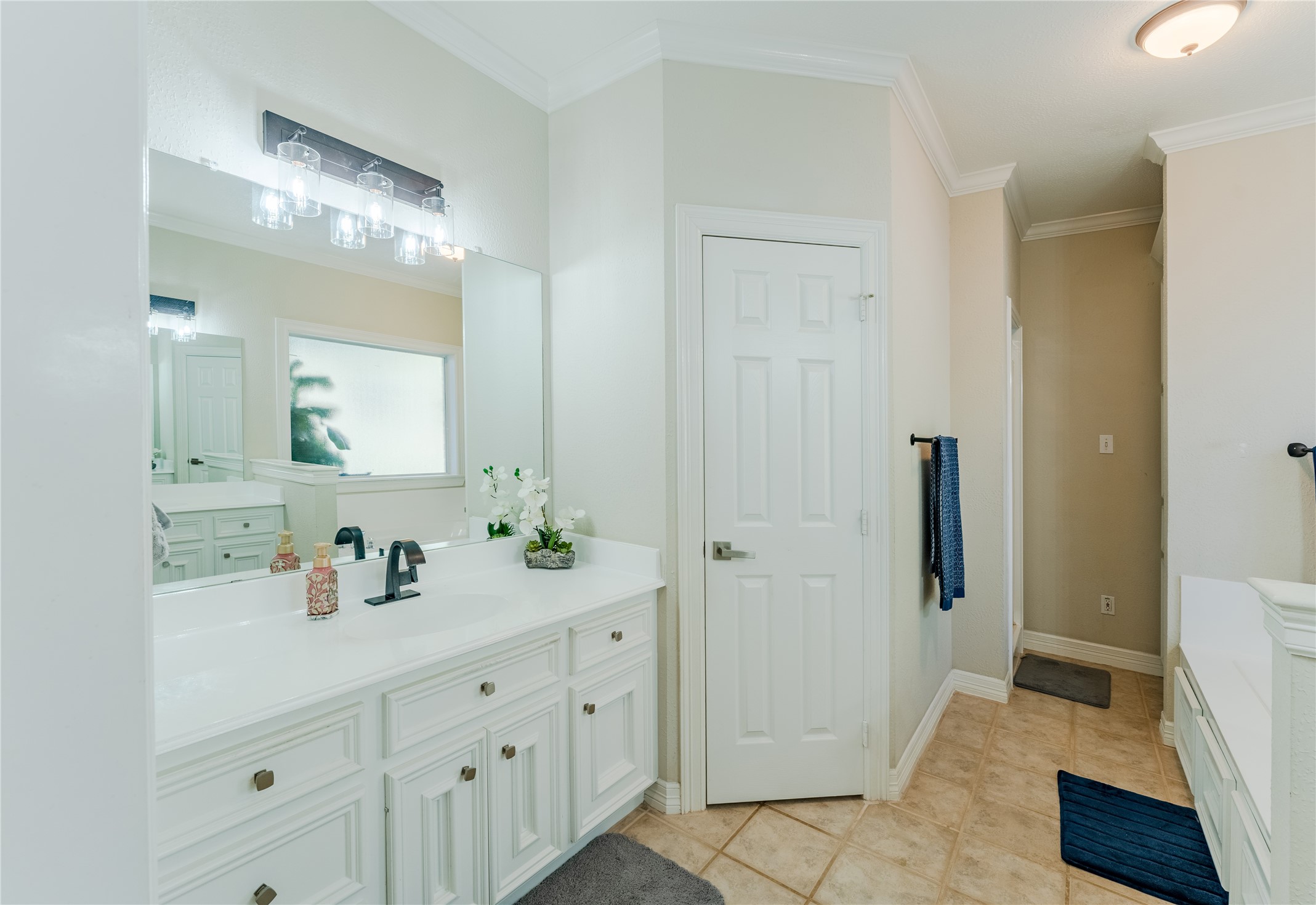 24102 Baneberry Road Magnolia, TX 77355 - Photo 26 of 39 a spacious bathroom with a double vanity sink a mirror and a