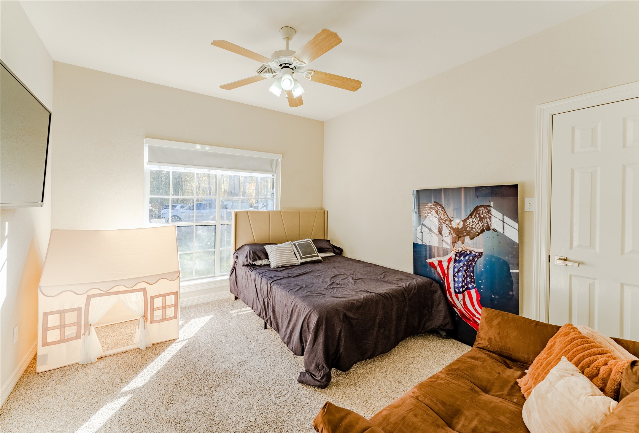 24102 Baneberry Road Magnolia, TX 77355 - Photo 29 of 39 a bedroom with a bed and a chandelier