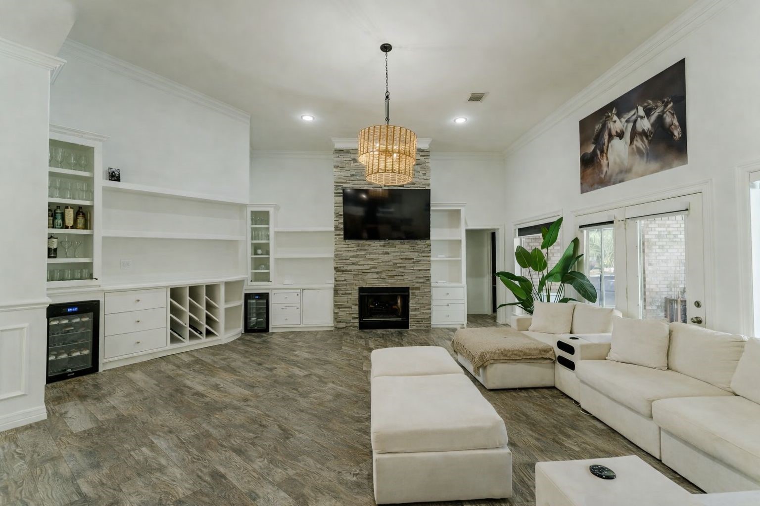24102 Baneberry Road Magnolia, TX 77355 - Photo 7 of 39 a living room with furniture a fireplace and a chandelier