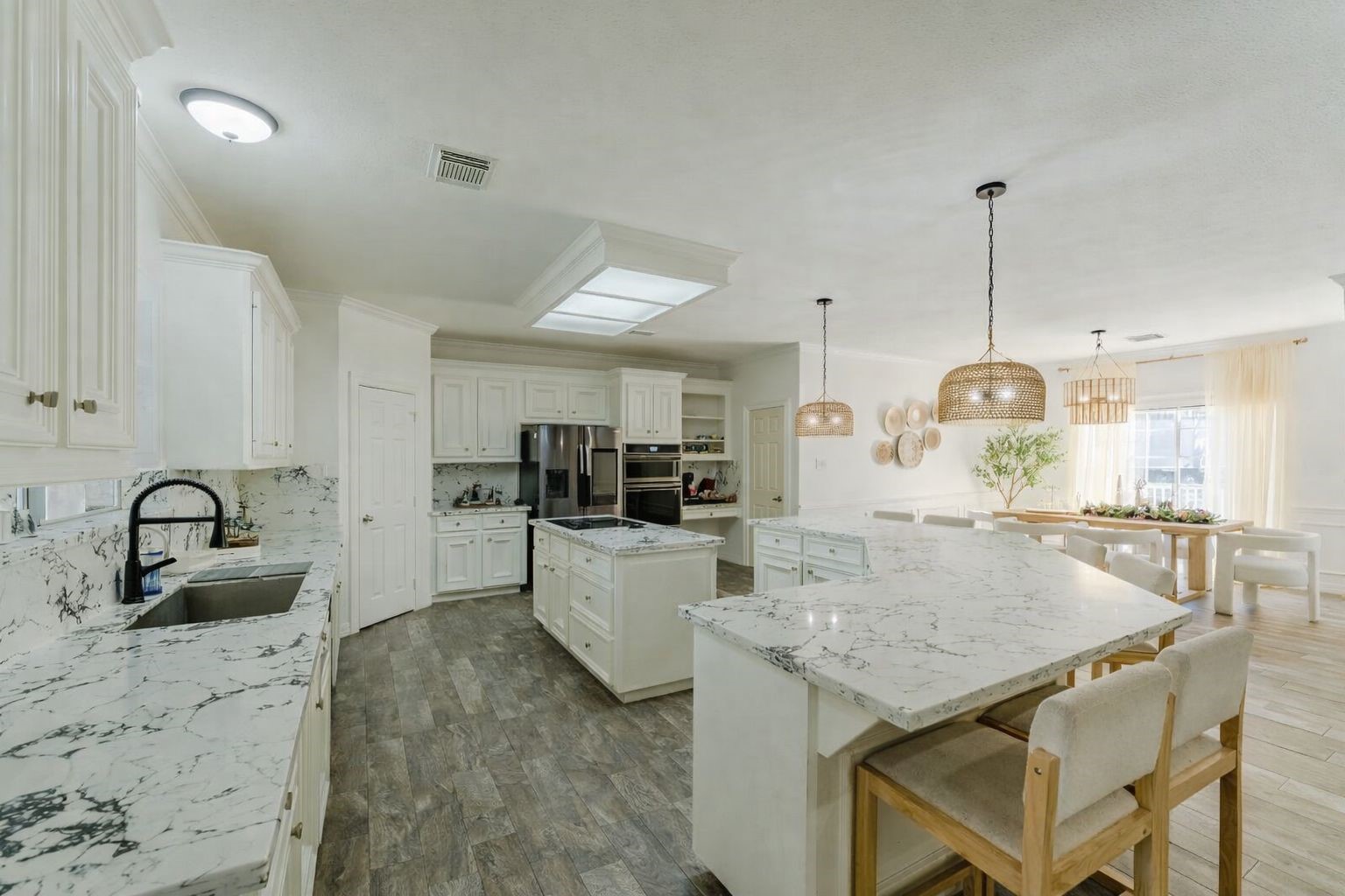 24102 Baneberry Road Magnolia, TX 77355 - Photo 10 of 39 a kitchen with granite countertop a table and chairs in it