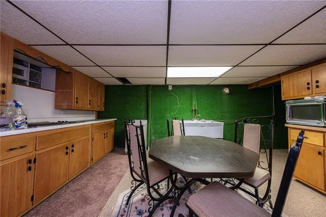 a kitchen with a table chairs and a refrigerator