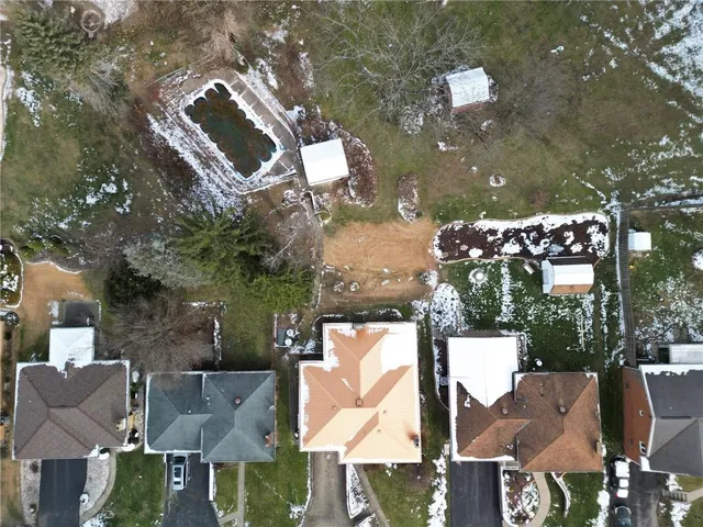 an aerial view of multiple houses with yard