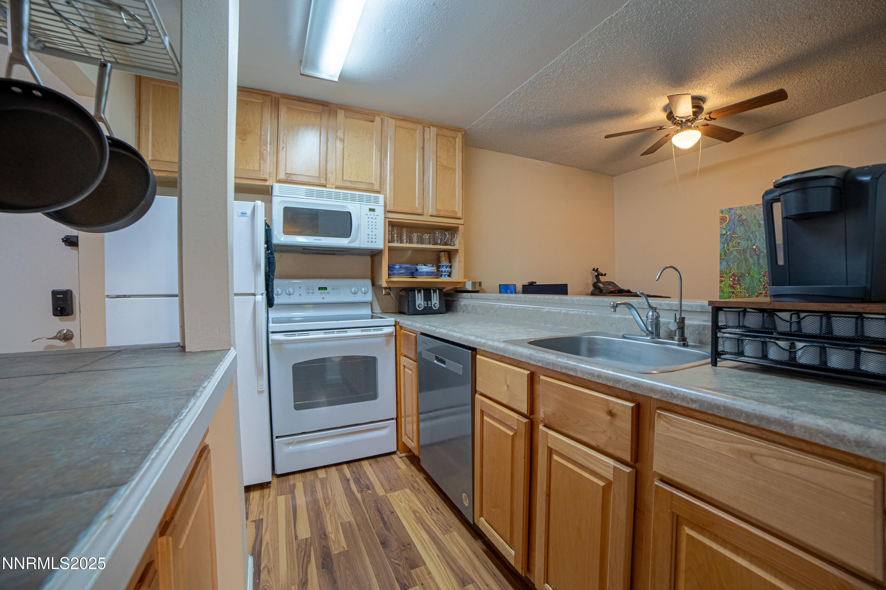 2700 Plumas Street, Unit 112 Reno, NV 89509 - Photo 2 of 17 a kitchen with stainless steel appliances granite countertop a stove and a microwave