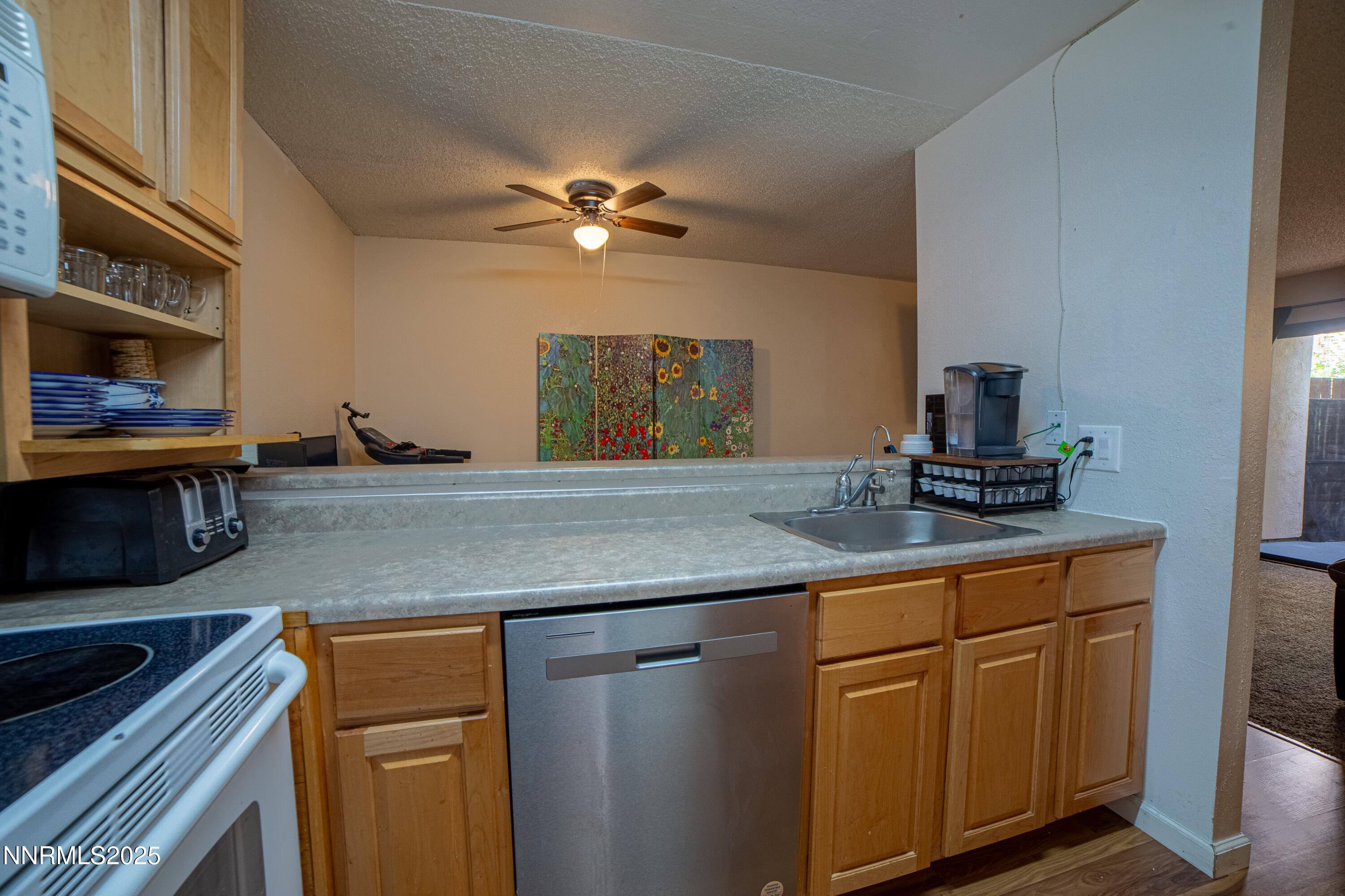 2700 Plumas Street, Unit 112 Reno, NV 89509 - Photo 3 of 17 a kitchen with stainless steel appliances granite countertop a sink a stove and cabinets