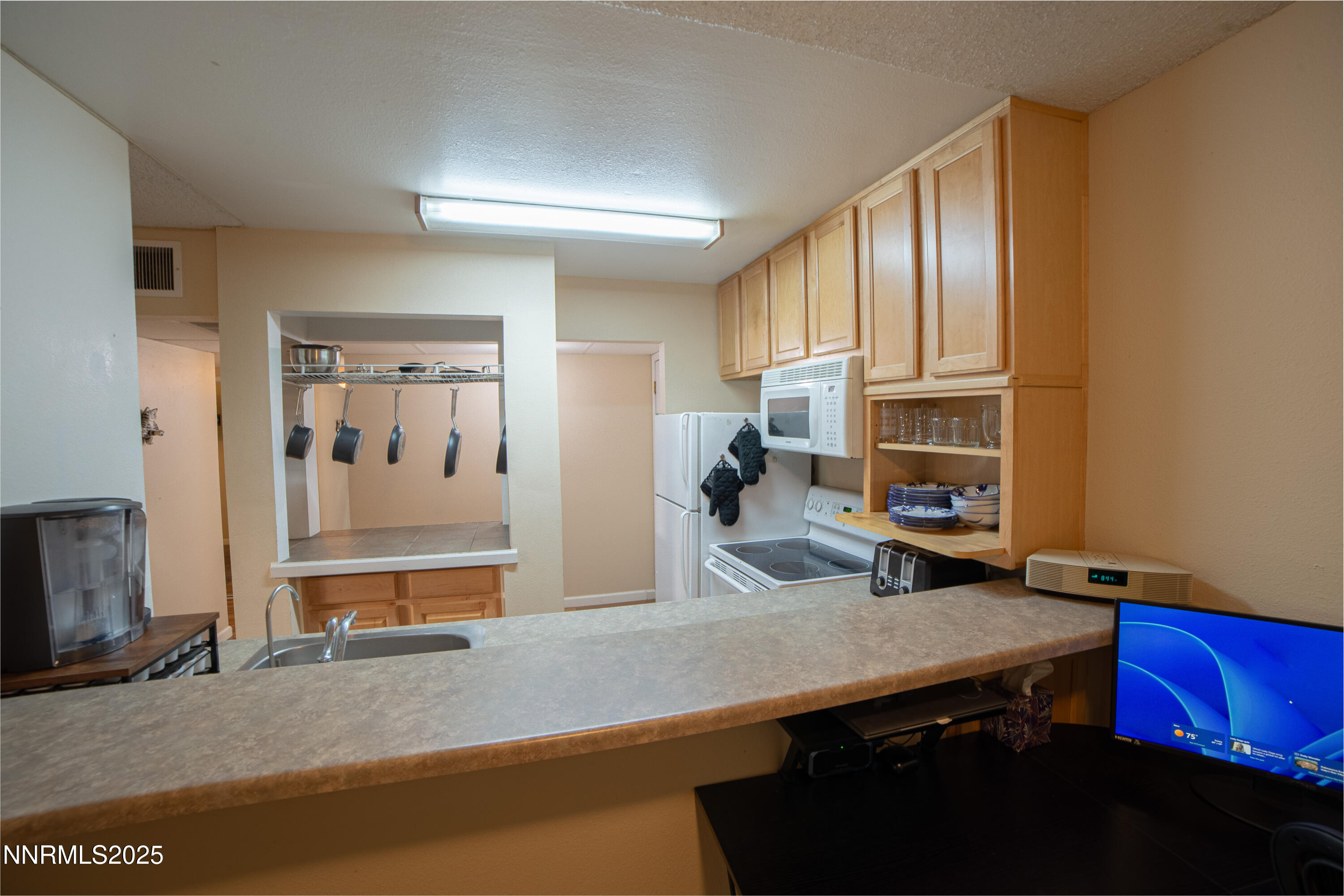 2700 Plumas Street, Unit 112 Reno, NV 89509 - Photo 5 of 17 a kitchen with stainless steel appliances a sink stove and cabinets