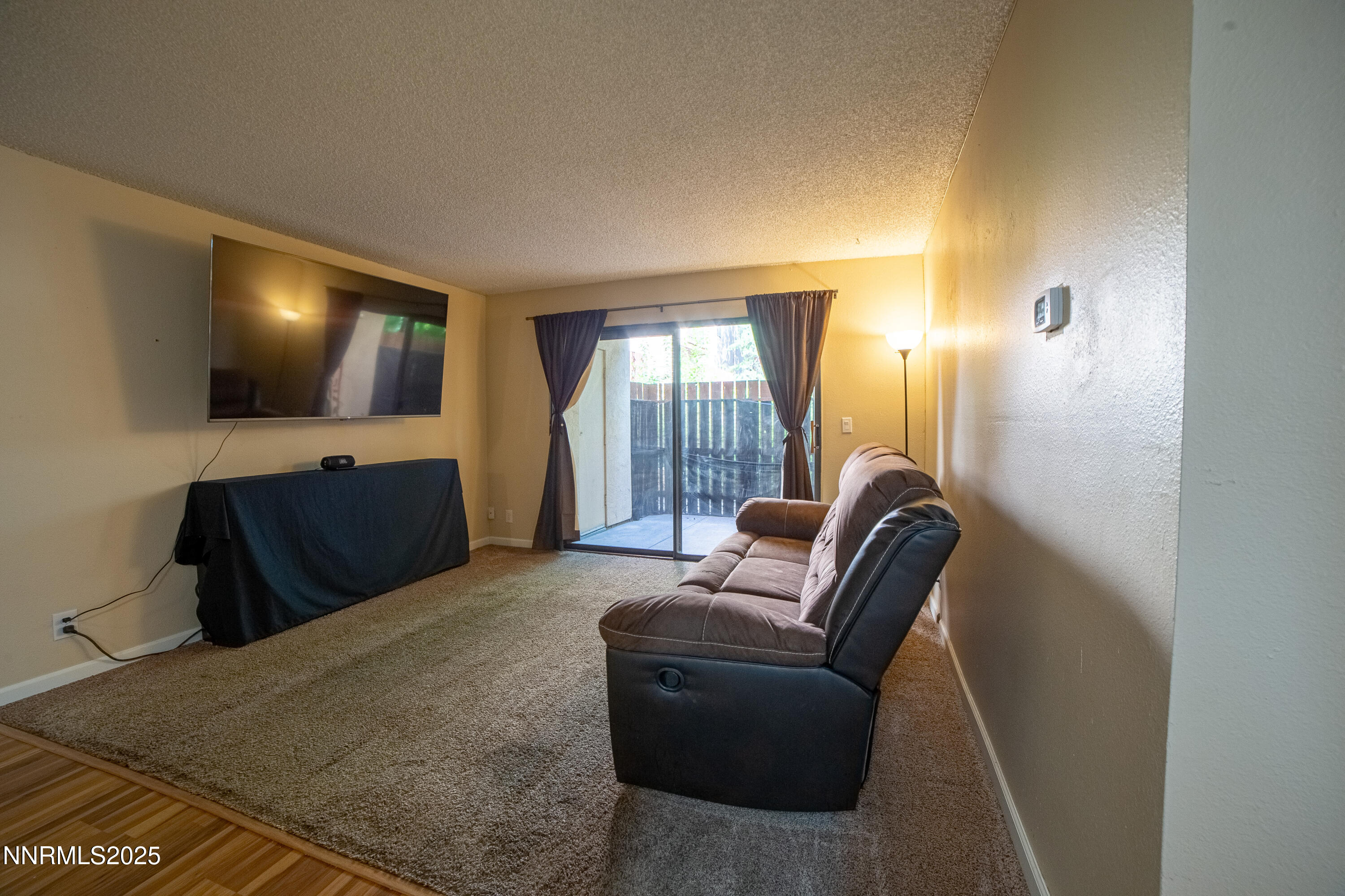 2700 Plumas Street, Unit 112 Reno, NV 89509 - Photo 9 of 17 a living room with furniture and a flat screen tv