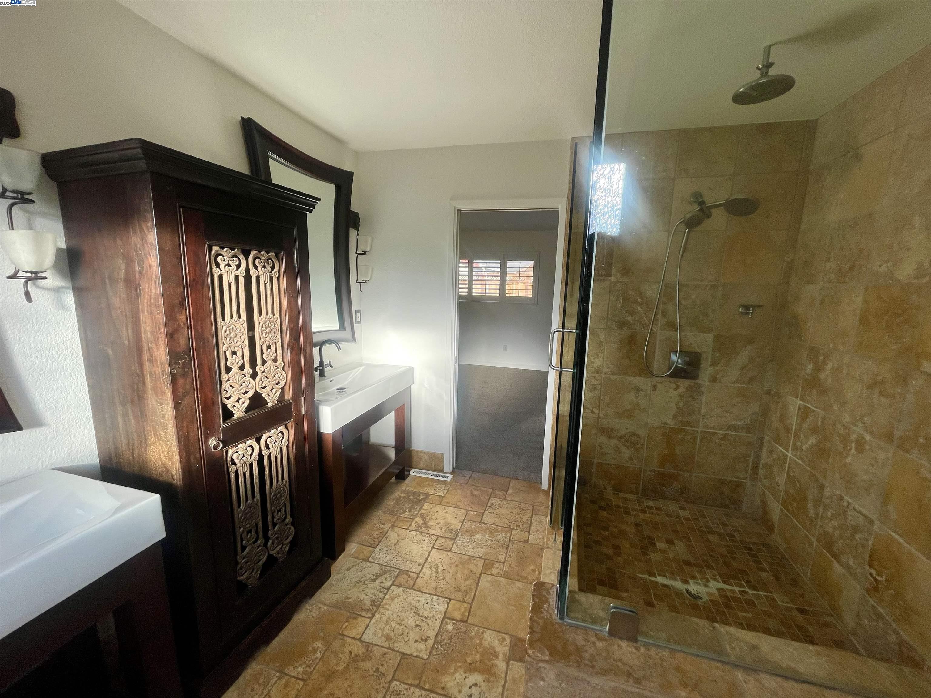 1361 Hudson Way Livermore, CA 94550 - Photo 18 of 23 a bathroom with a glass door shower a sink and a toilet