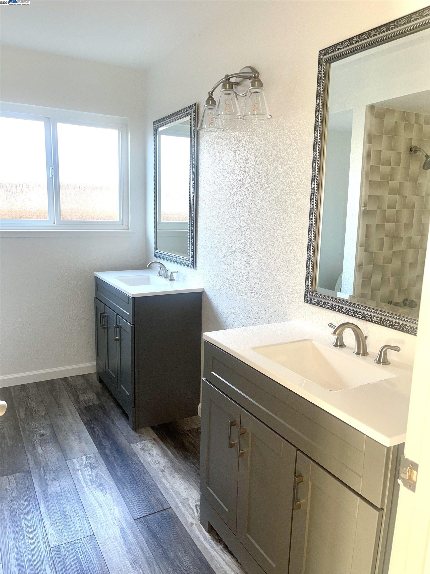 1361 Hudson Way Livermore, CA 94550 - Photo 22 of 23 a bathroom with a sink and two mirror