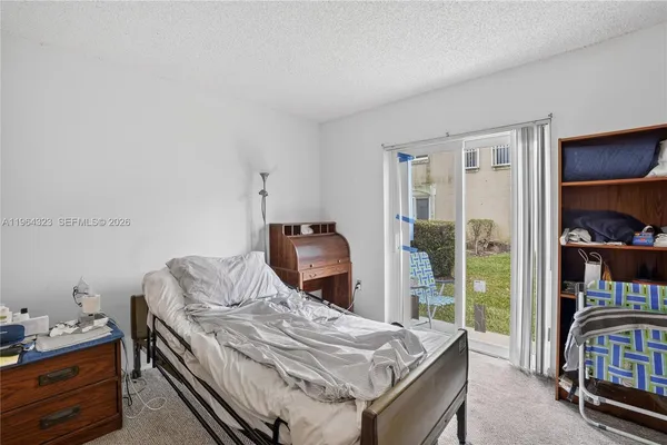 a bedroom with bed and a bookshelf