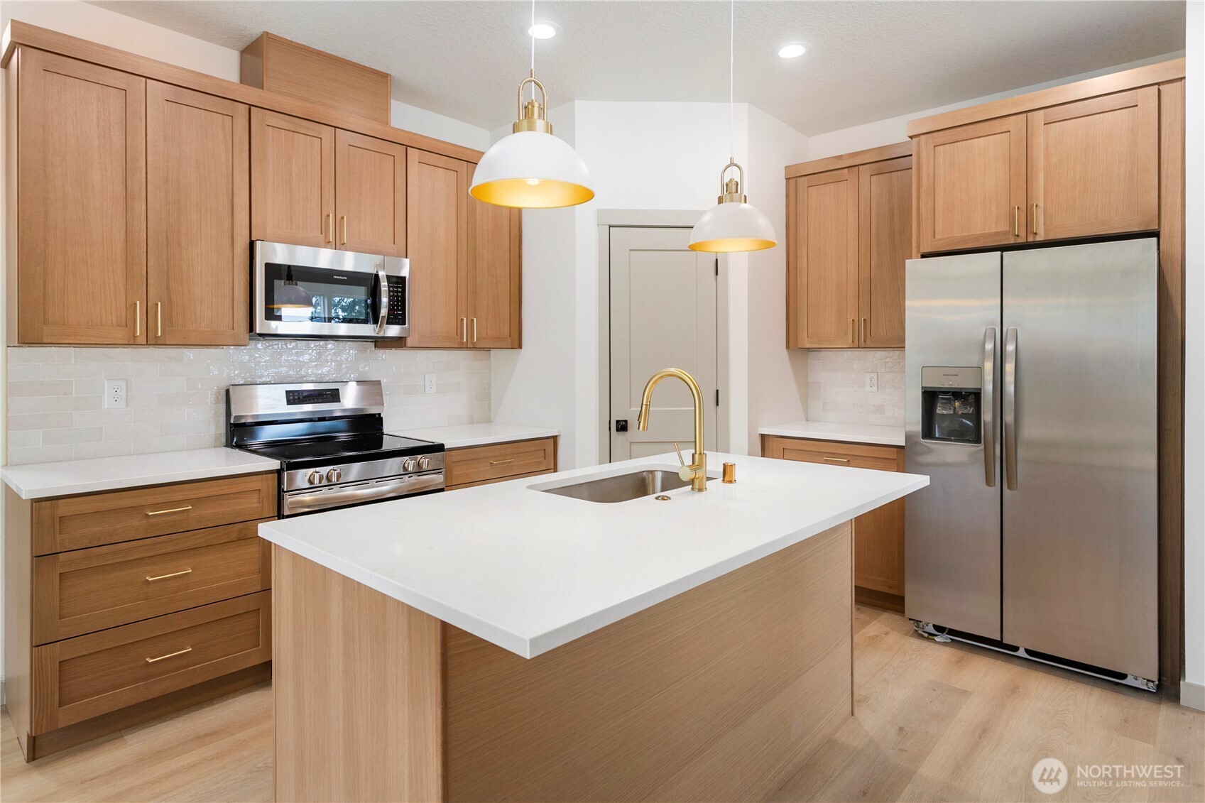 2333 West Castleman Street Longview, WA 98632 - Photo 11 of 39 a kitchen with stainless steel appliances a sink a stove a microwave a refrigerator and cabinets