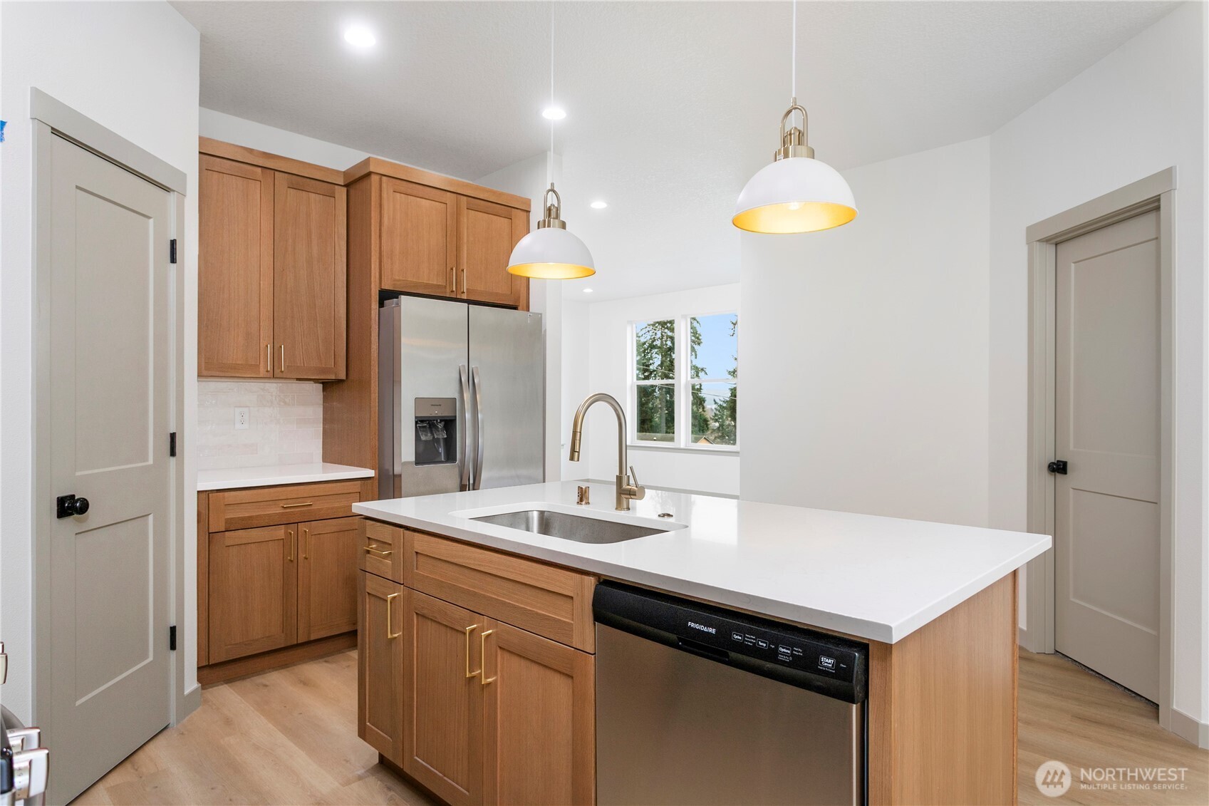 2333 West Castleman Street Longview, WA 98632 - Photo 12 of 39 a kitchen that has a sink a stove and a refrigerator